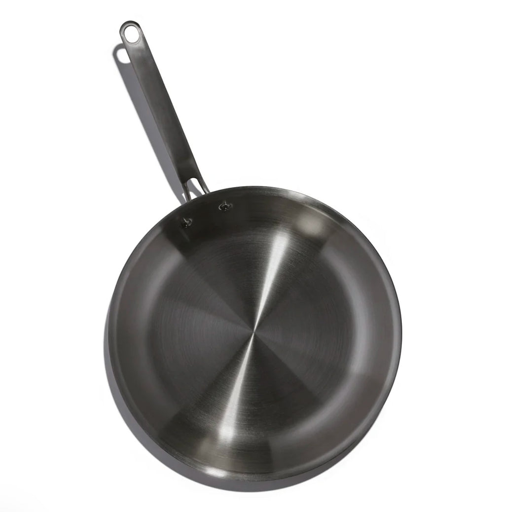 The Kitchen Table 12-inch stainless steel fry pan with a durable, fully clad metal body for even heat distribution.