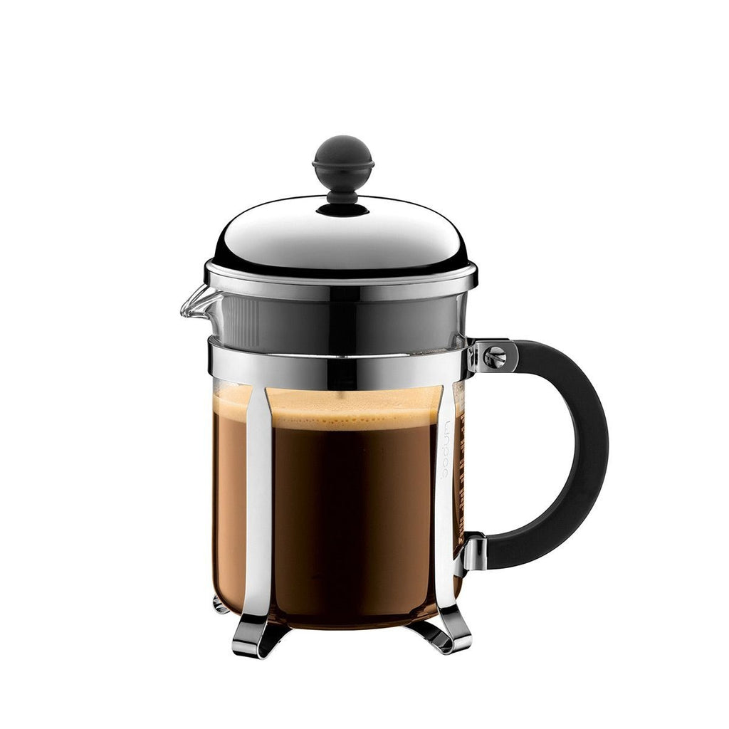 The Kitchen Table Bodum Chambord 4-cup French press coffee maker with chrome frame, glass carafe, and black handle.