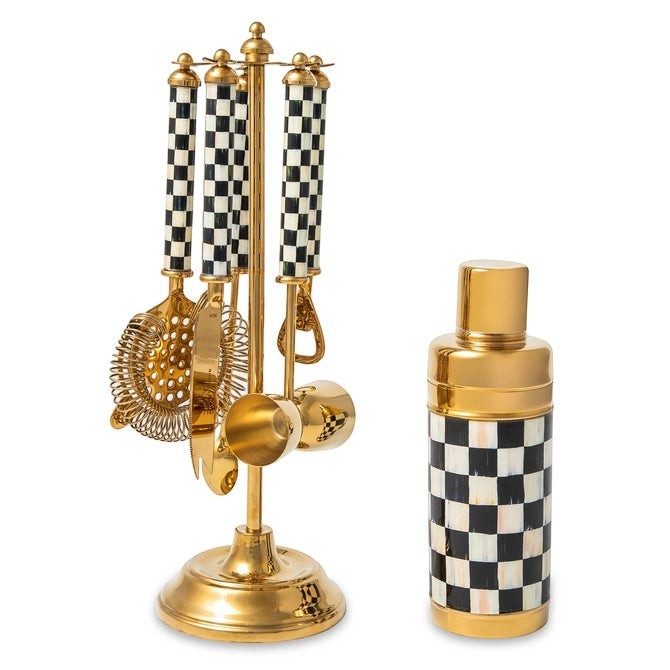 The Kitchen Table bar tool set with black and white checkered resin handles and polished gold-tone metal accents.