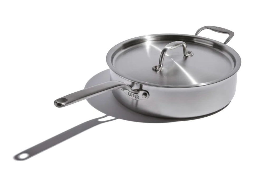 The Kitchen Table EATER 4 quart stainless steel sauté pan with matching lid and long handle on a white background.