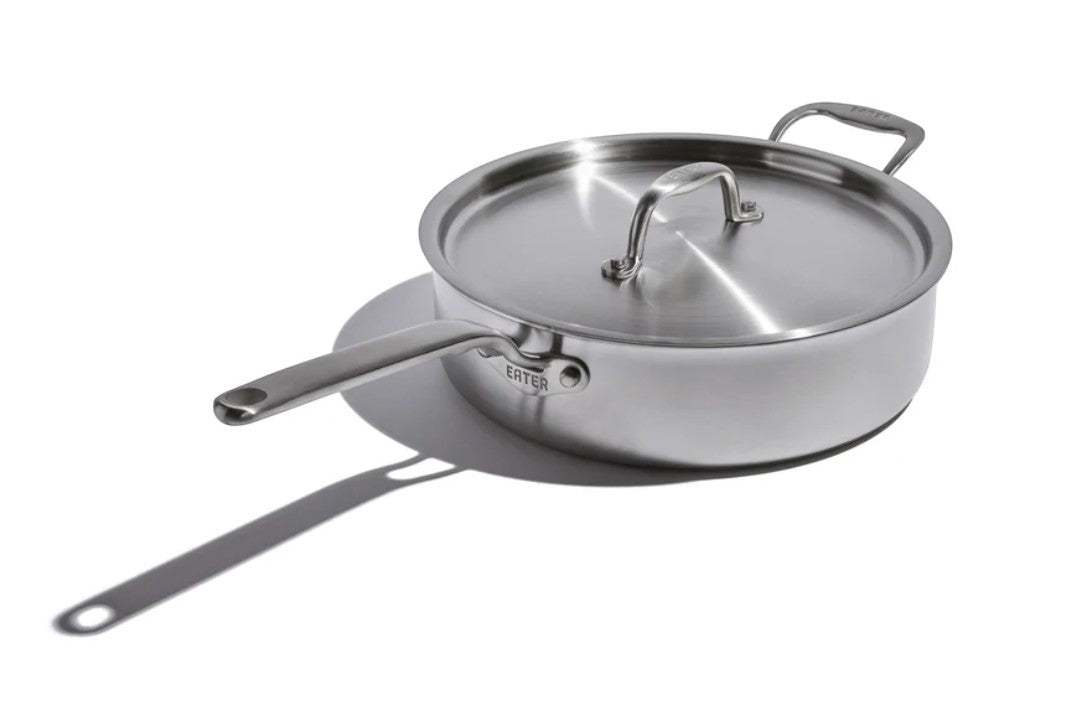 The Kitchen Table EATER 4 quart stainless steel sauté pan with matching lid and long handle on a white background.