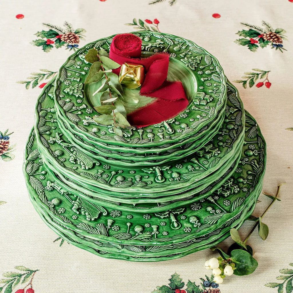 The Kitchen Table Fiabe di Natale green ceramic charger plate with intricate handsculpted holiday festive motifs.