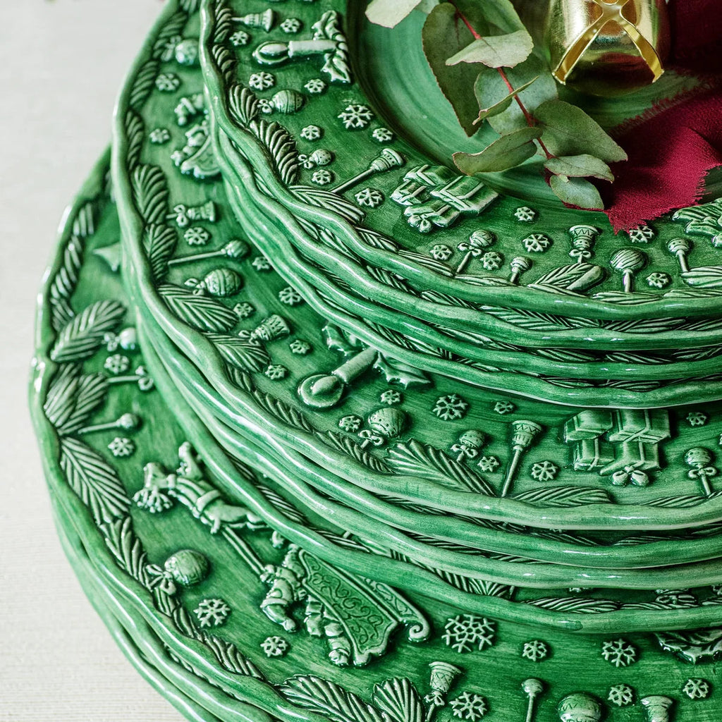 The Kitchen Table Fiabe di Natale green salad plate with handsculpted festive holiday scenes and embossed details.