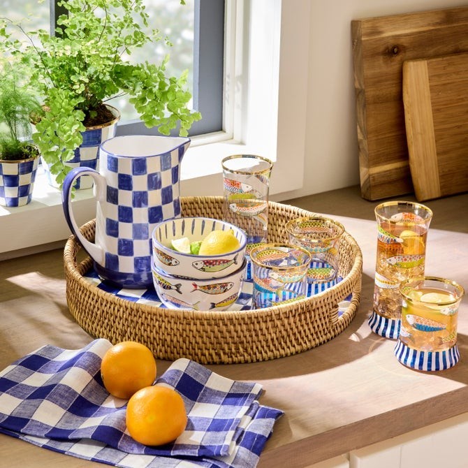 The Kitchen Table Go Fish tumbler glass set featuring nautical fish patterns, navy stripes, and gold lustre rims.