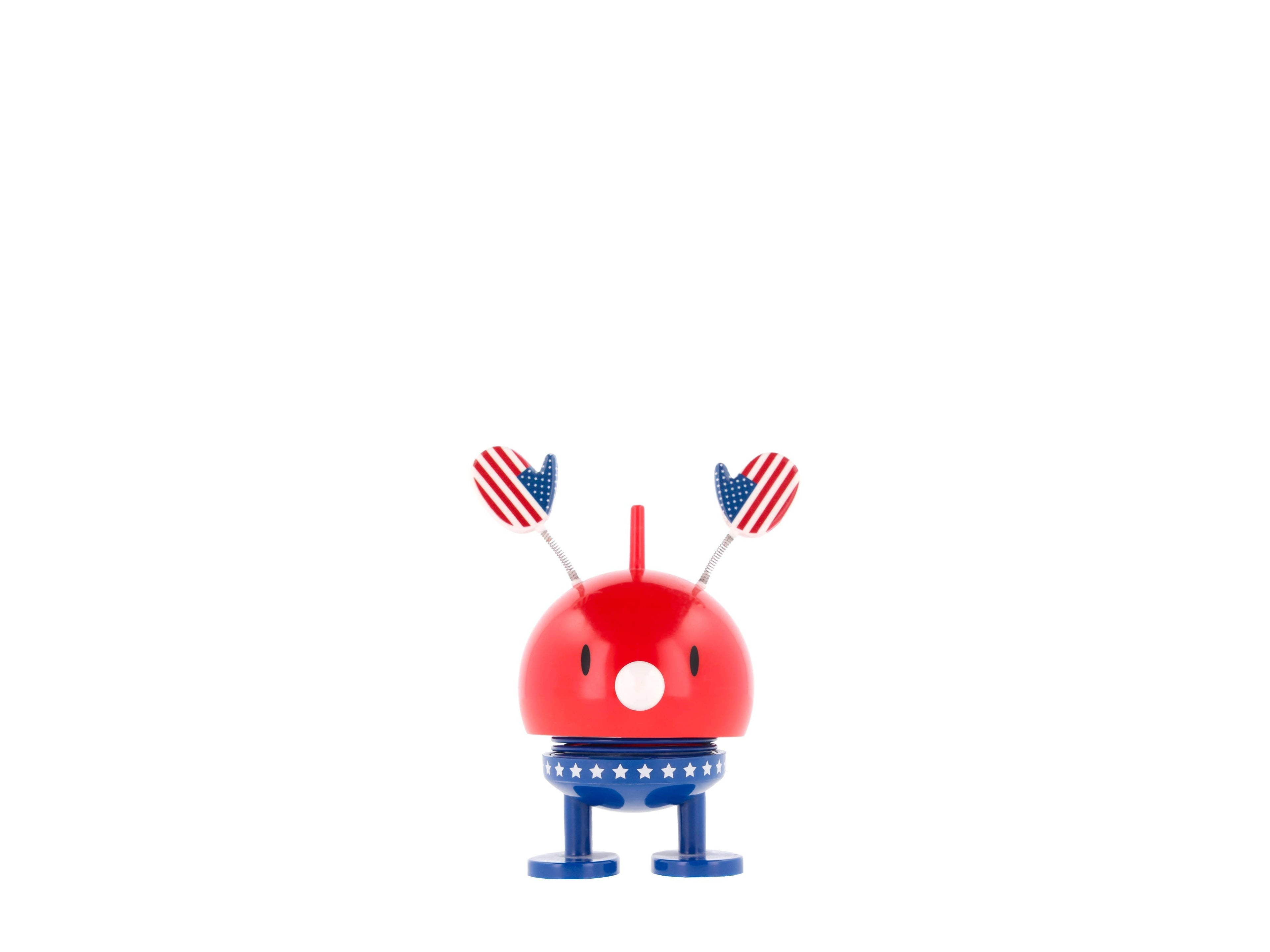 The Kitchen Table Hoptimist Roligan USA figurine with a red body, blue star-patterned base, and American flag hands.