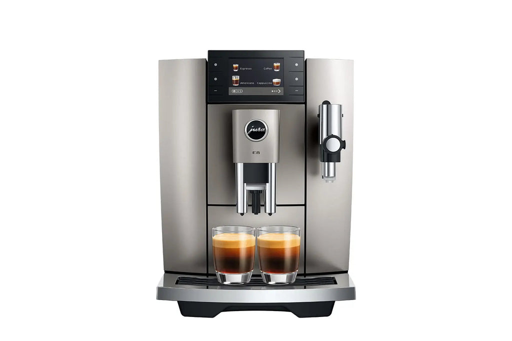 The Kitchen Table Jura E8 Midnight Silver automatic coffee machine with a digital display and two espresso glasses.