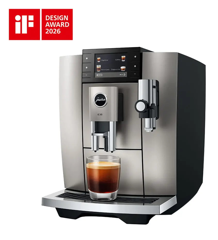 The Kitchen Table Jura E8 Midnight Silver automatic coffee machine with a glass of espresso and iF Design Award logo.