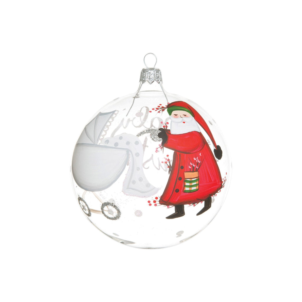 The Kitchen Table Old St. Nick handpainted glass ornament featuring Santa Claus and a baby carriage for a first Christmas