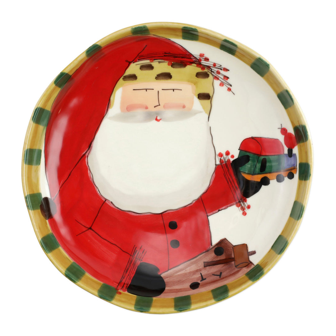 The Kitchen Table Old St. Nick round shallow bowl featuring a hand-painted Santa Claus holding a toy train