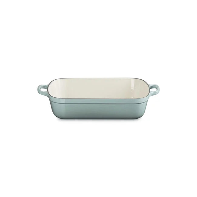 The Kitchen Table Le Creuset Signature rectangular enameled cast iron roaster in a soft blue finish with wide loop handles.