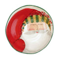 Vietri hand-painted ceramic pasta bowl featuring a whimsical Santa Claus design with a green striped rim.