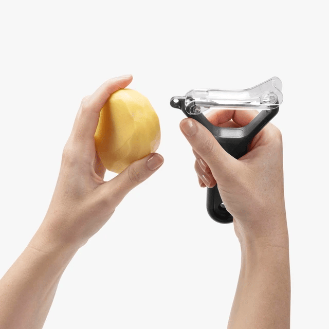The Kitchen Table Sharple Y-Peeler with self-sharpening blade peeling a potato with ergonomic handle control
