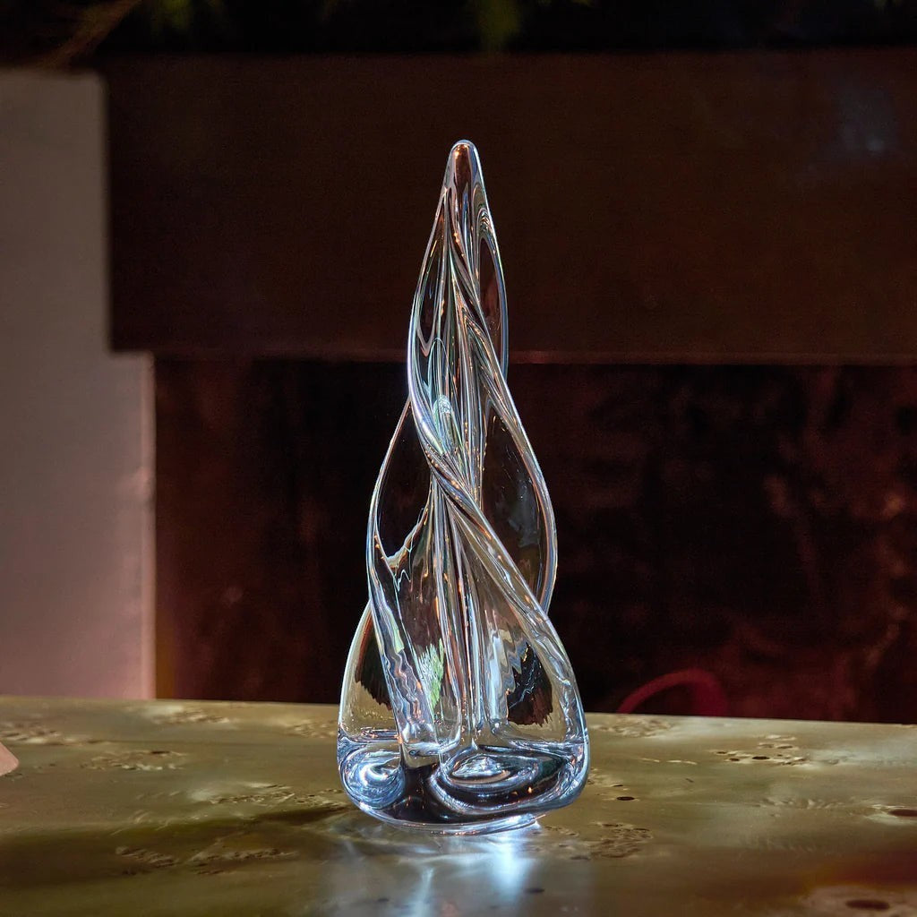 The Kitchen Table clear glass four-sided evergreen sculpture with a hand-formed spiral flame design.