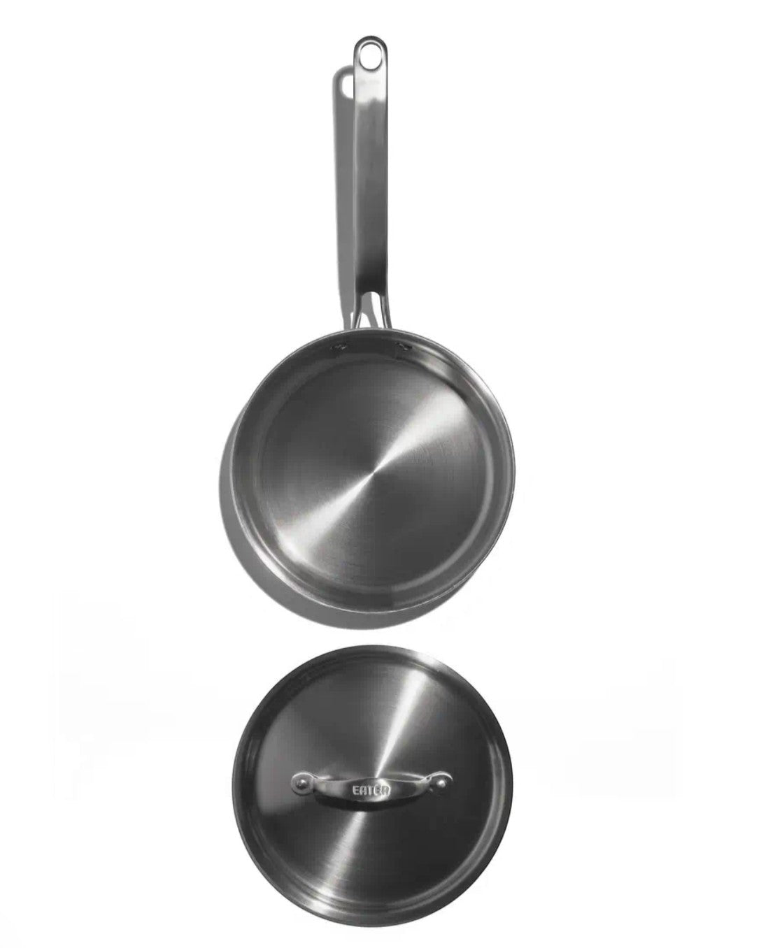 The Kitchen Table 1.5 quart stainless steel mini sauté pan with matching lid, top-down view on white background.