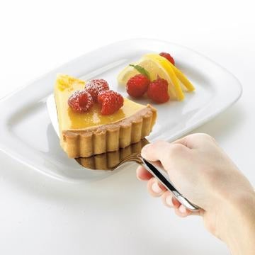 The Kitchen Table Cuisipro Tempo stainless steel pie server lifting a slice of tart on a white plate
