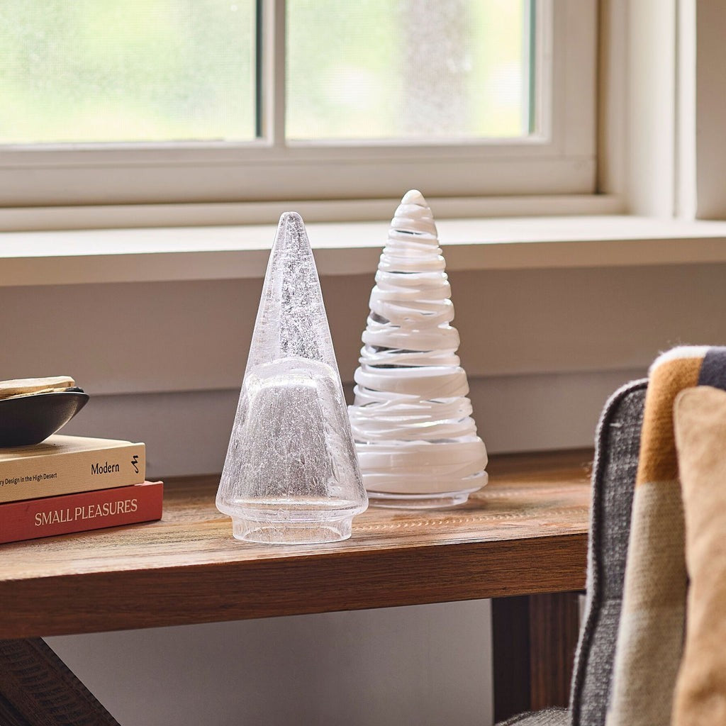 The Kitchen Table Vela Conical Evergreen glass tree decorations with bubble details on a wooden table.