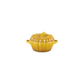 The Kitchen Table pumpkin-shaped stoneware mini cocotte in a vibrant yellow autumn glaze with a lid.