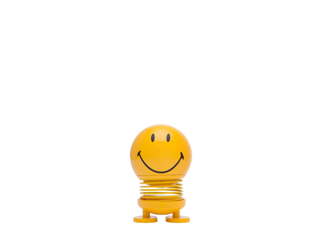 The Kitchen Table yellow Smiley Hoptimist figurine with a spring base and a cheerful beaming smile